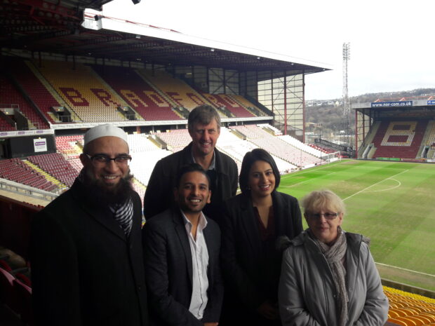 Picture of Sara Khan with four other people in a football stadium in Bradford