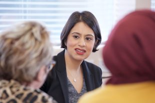 Lead Commisioner Sara Khan speaks to two women